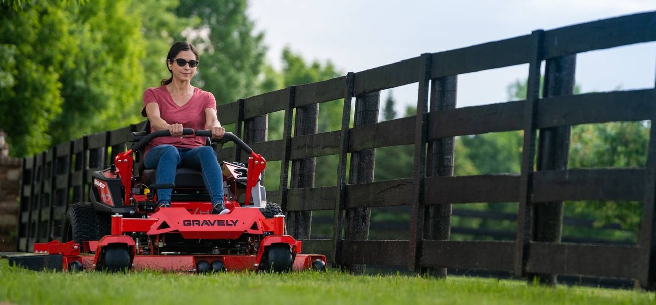 Adult man engaging in lawn care with a powerful gas-powered mower.